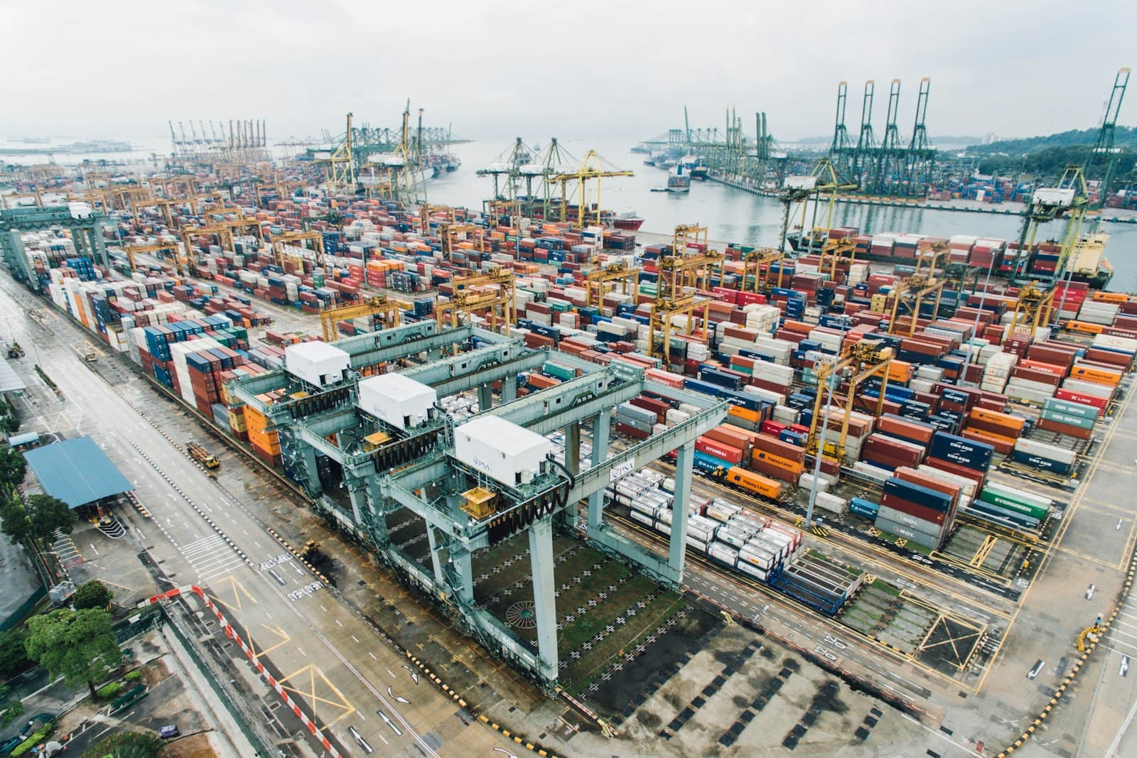 Aerial view of a container port with stacked shipping containers