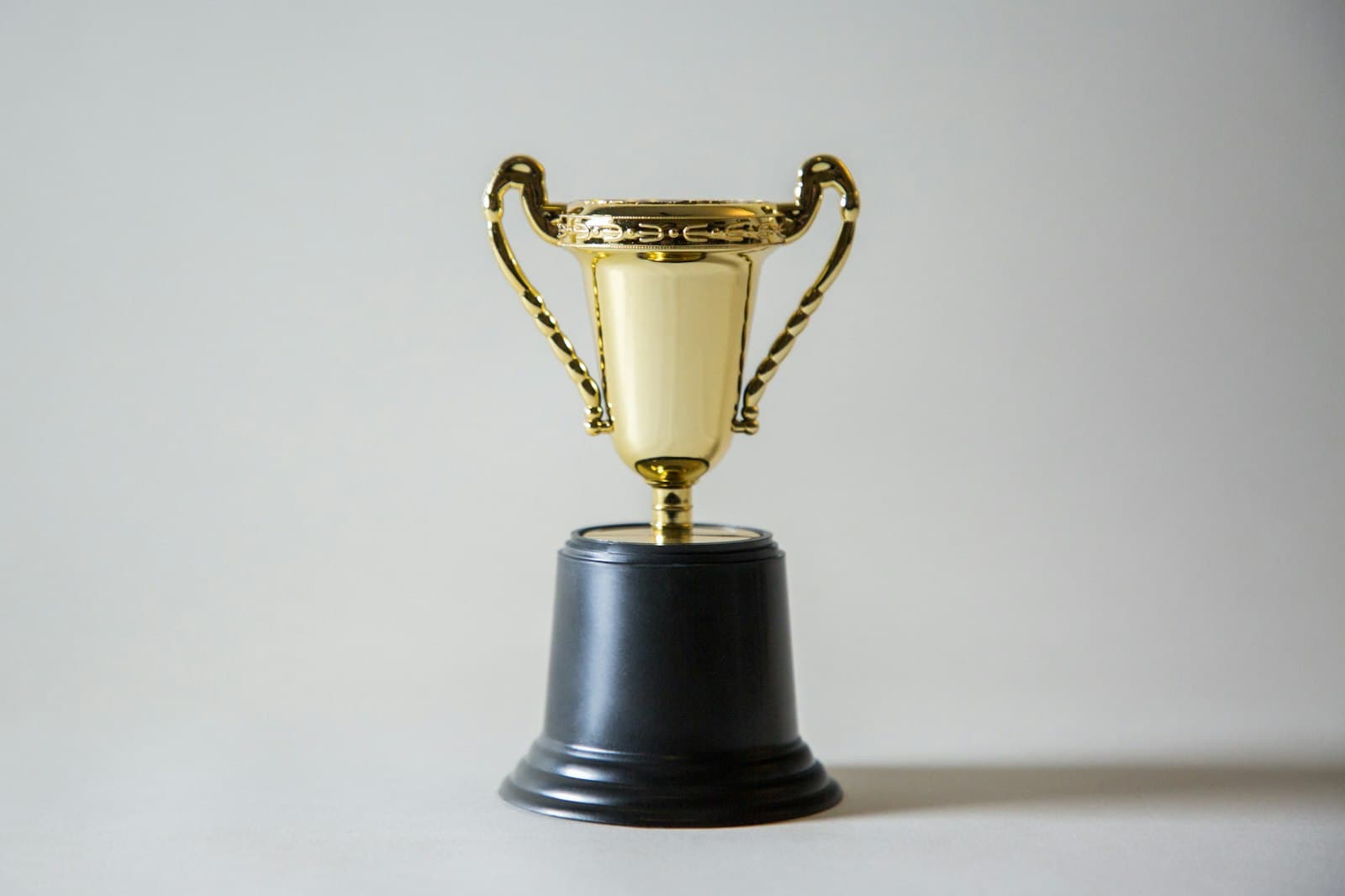 A gold trophy on a grey table