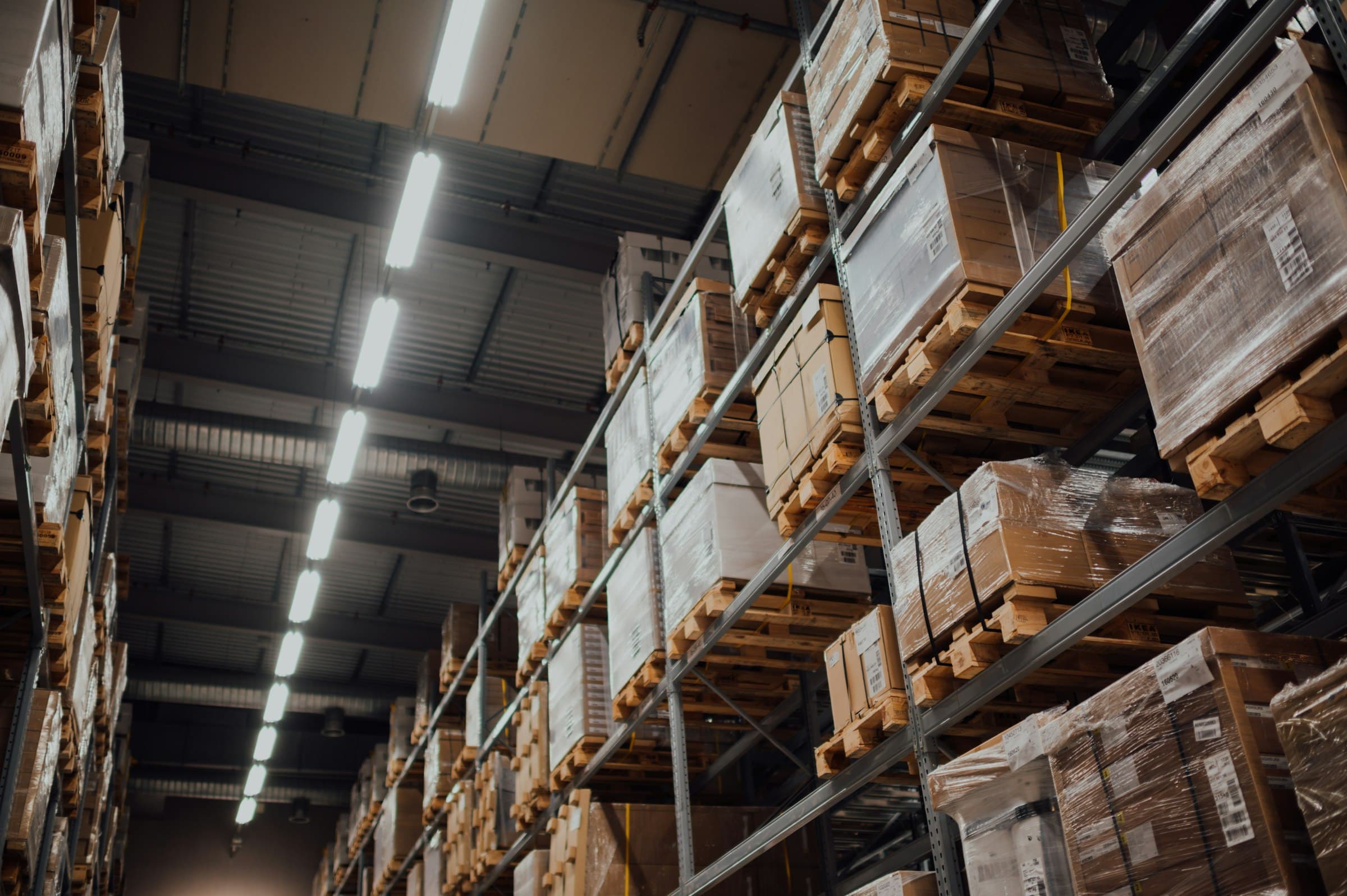 Warehouse racks stacked with boxed stock on pallets